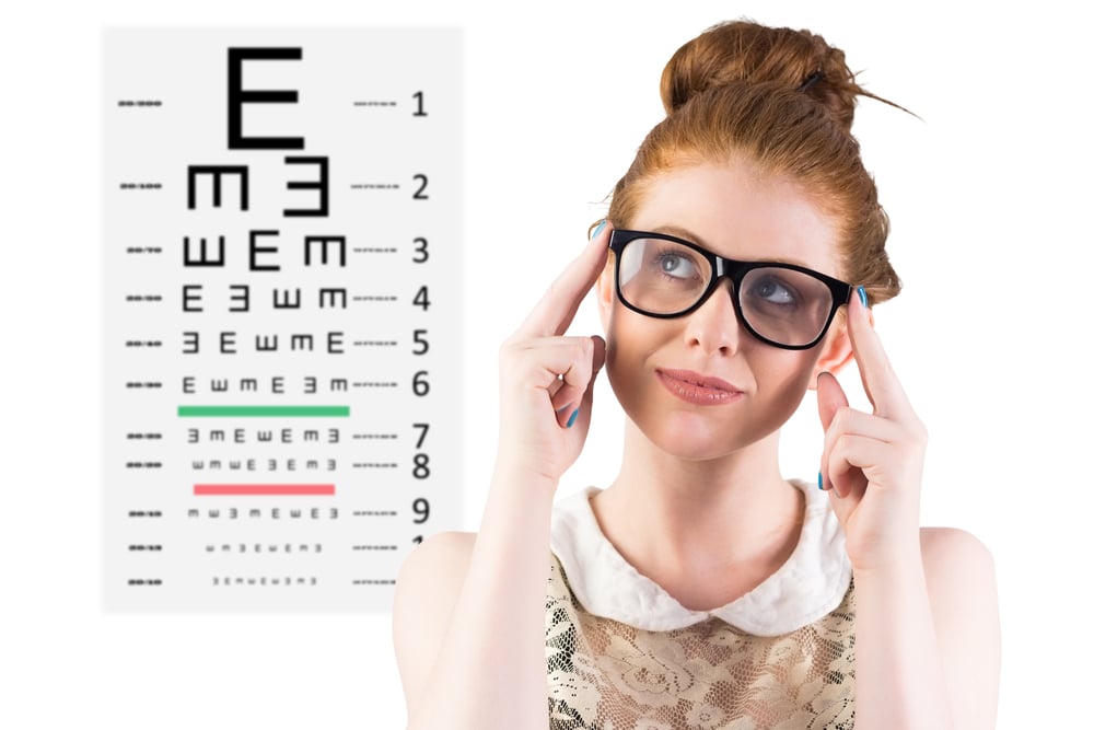 Hipster redhead looking up thinking against eye test